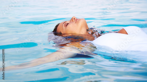 Woman, calm float and ocean swimming for travel, holiday and sea water on tropical island. Hawaii, outdoor and female person relax on summer vacation with freedom and adventure by beach in paradise