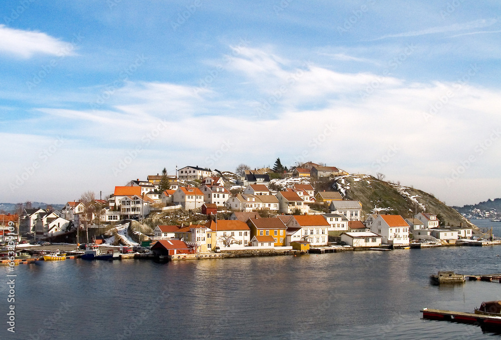 Island, water and houses at ocean in Norway, Europe and tourism, travel or vacation. Exterior, home and Scandinavian buildings at sea, vintage architecture or traditional property with boats at port