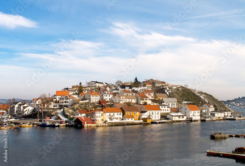 Island, water and houses at ocean in Norway, Europe and tourism, travel or vacation. Exterior, home and Scandinavian buildings at sea, vintage architecture or traditional property with boats at port