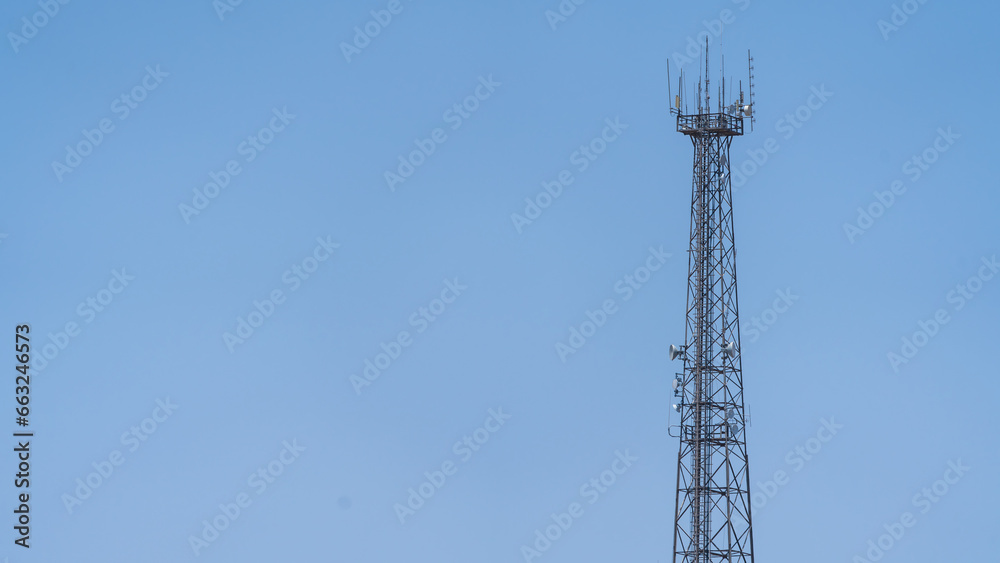 Cell phone tower set against a blue sky Cell phone tower set against a blue sky