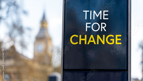 Time for change written on a sign with Elizabeth Tower and Big Ben in the background