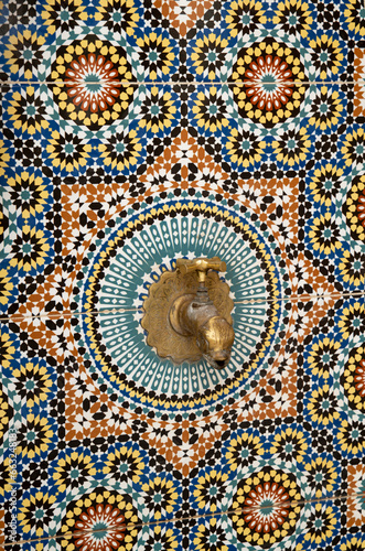 Zellige ceramic tiles on wall with water tap in Morocco