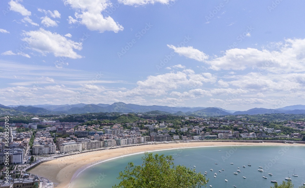 Panoramic aerial view of San Sebastian (Donostia) on a summer day with some clouds in the sky, Spain