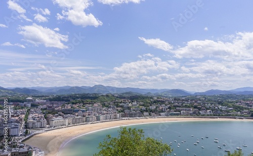 Panoramic aerial view of San Sebastian (Donostia) on a summer day with some clouds in the sky, Spain