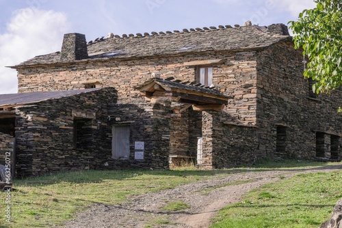 Stone house in the middle of the countryside. Typical house of the black tile villages photo
