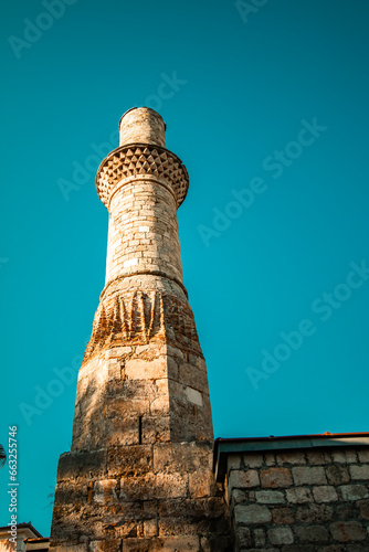 Kesik Minaret (Korkut Mosque), located among the historical structures and fascinating natural beauties of Antalya's Kaleici. Antalya, Turkey. photo