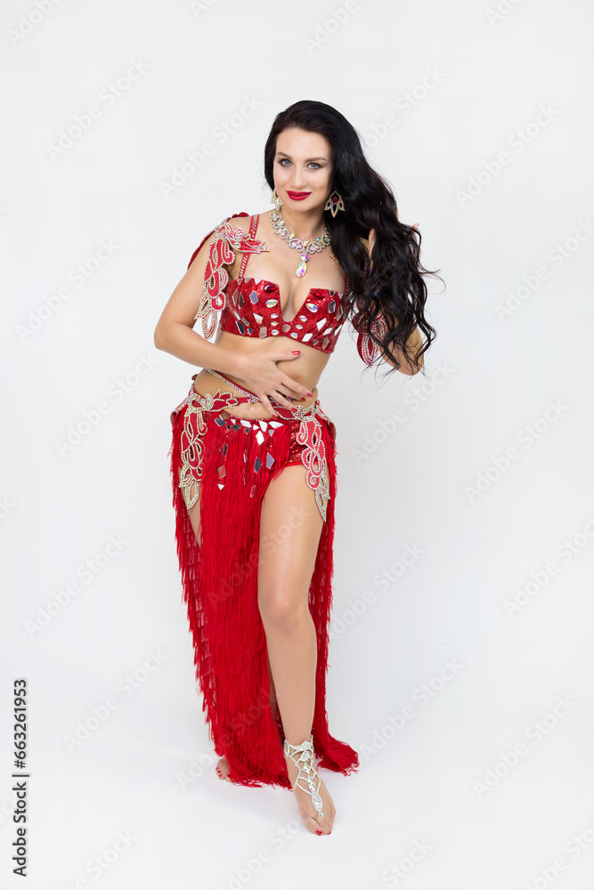Caucasian woman dancer performer of oriental dances on a gray background. Caucasian woman dancer performer of oriental dances on a gray background.