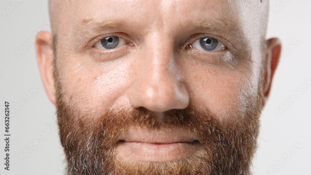 Obraz premium Handsome person look at camera close up. Young adult man face portrait. Stylish 30s guy on isolated white background. Attractive male model. Modern millennial people. Brutal bearded style. Barber shop