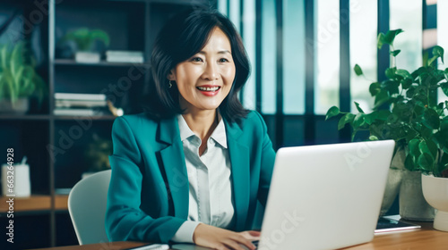 Asian business woman using a laptop in the office
