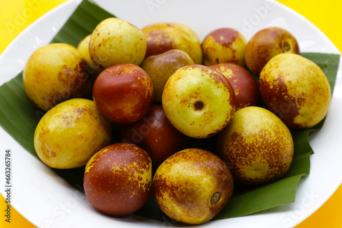 Fresh jujube fruit on yellow background