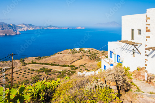 VIew of sea from mountain with white house in foreground in Plaka village, Milos island, Cyclades, Greece