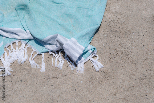 Fototapeta Naklejka Na Ścianę i Meble -  Beach towel lying on white sand on a summer holidays beach scene