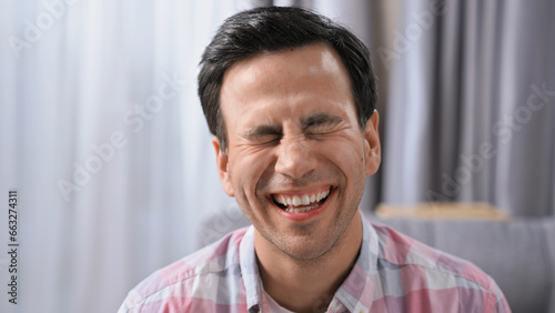 Silly burst out laugh. Happy 30s person head shot. Young adult man look at camera. One nice guy joke. Fun male face close up. Joy loud laughter. Funny hard laughing. Human portrait. Positive emotion.