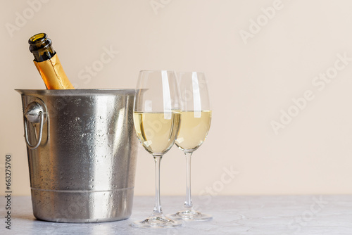 Two champagne glasses and bottle in ice bucket