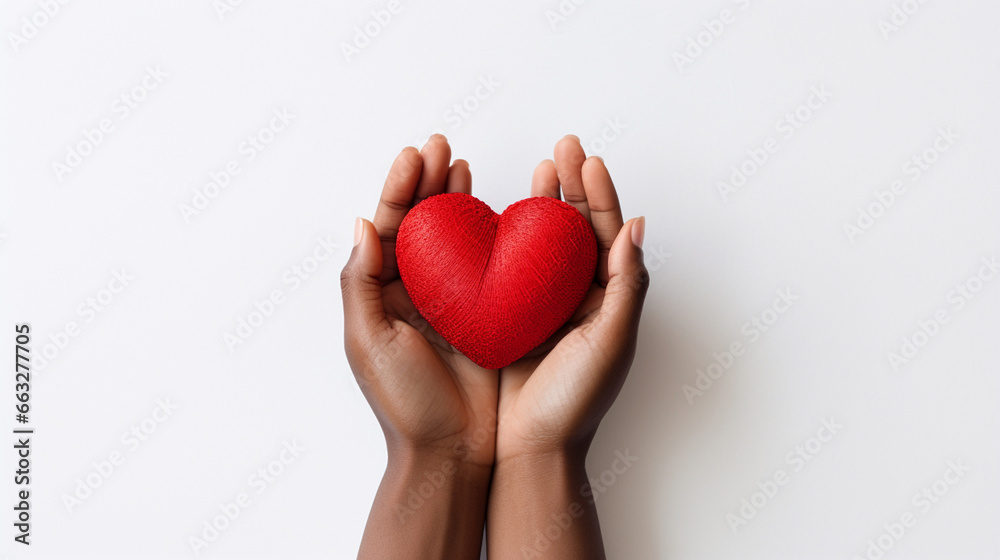 dark-skinned hands holding a red heart on a white background dark-skinned hands holding a red heart on a white background