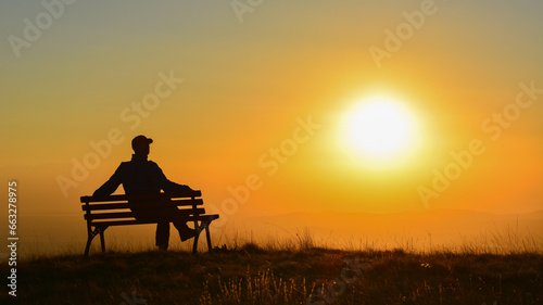 Silhouette of a Man Watching the Sun