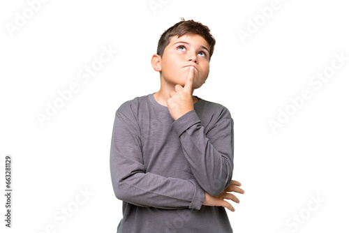 Little caucasian kid over isolated chroma key background having doubts while looking up