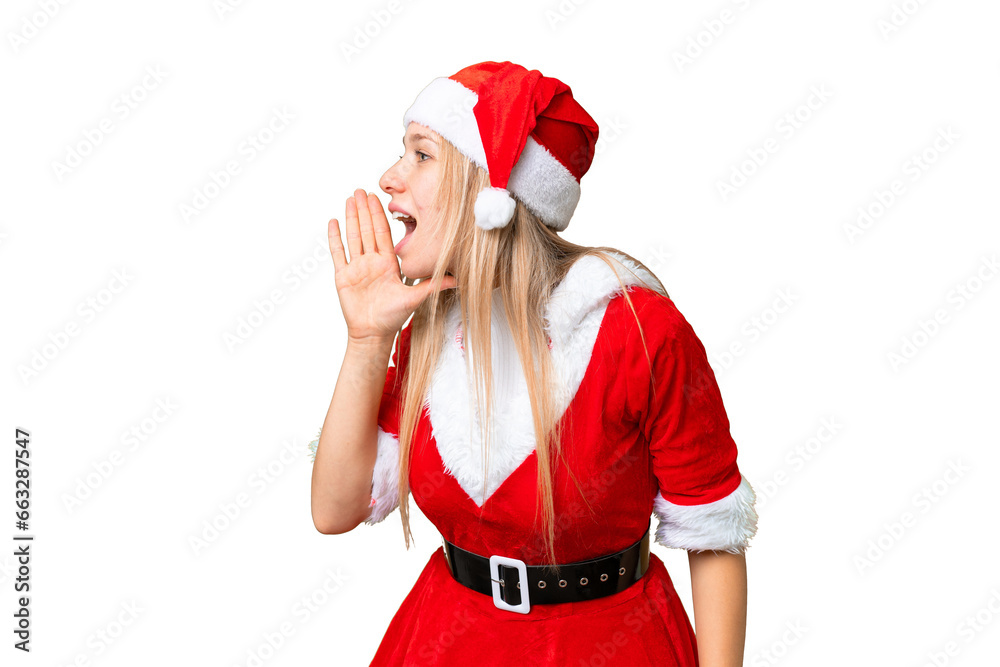 Young blonde woman with christmas hat over isolated chroma key background shouting with mouth wide open to the side