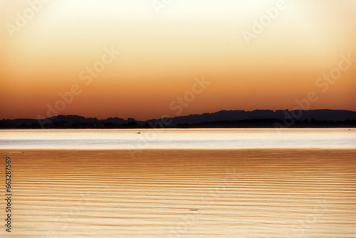 impression of lake chiemsee with golden shining light at the evening © HighDispersion