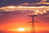 Sunrise with an electricity pylon and nature