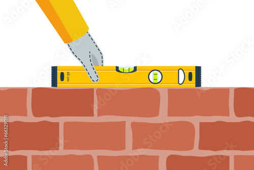 Building a wall. The process of building a brick wall, the builder holds a building level in hands. Vector illustration flat design. Isolated on white background.