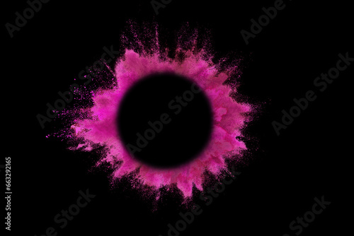 Explosion of colored pink powder with empty space circle for text, isolated on black background