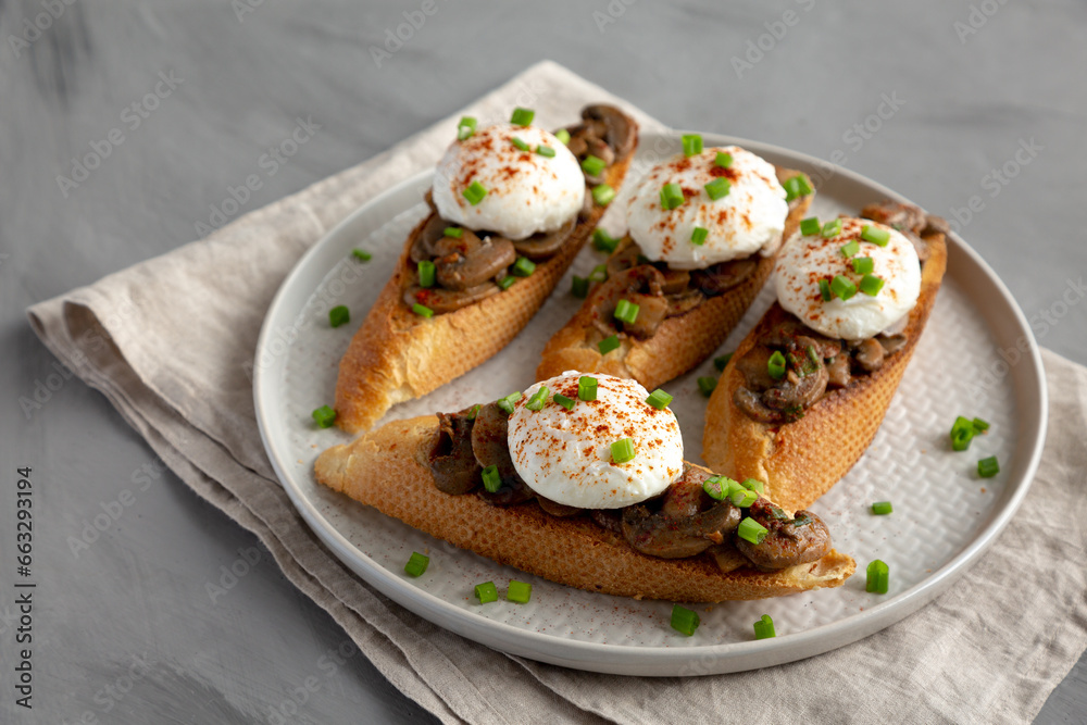 Homemade Creamy Mushroom Toasts on a Plate, side view.