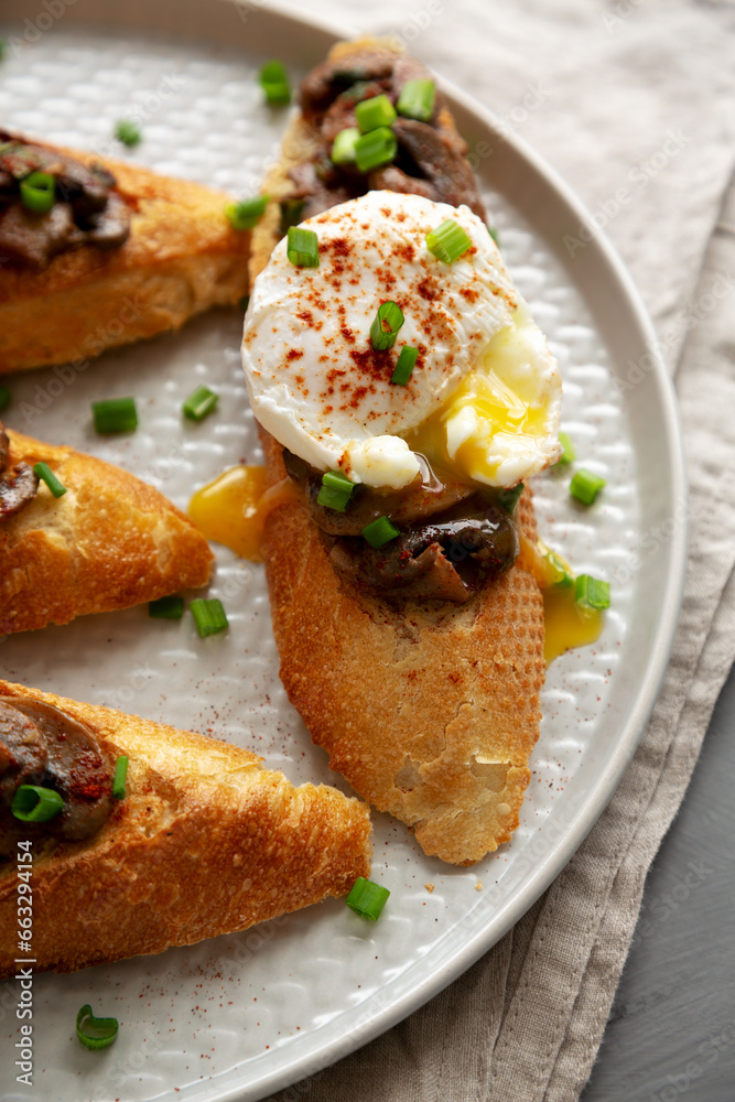 Homemade Creamy Mushroom Toasts on a Plate, side view. Close-up.