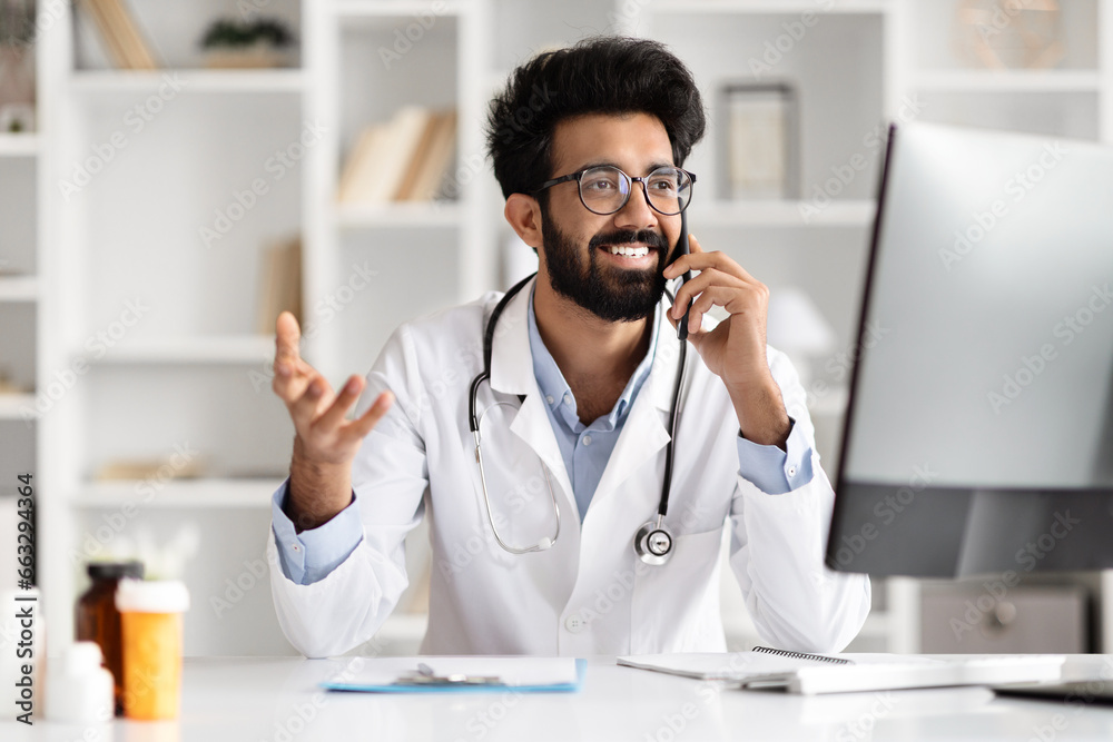 Young Physician Managing Work with Technology at Clinic Young Physician Managing Work with Technology at Clinic