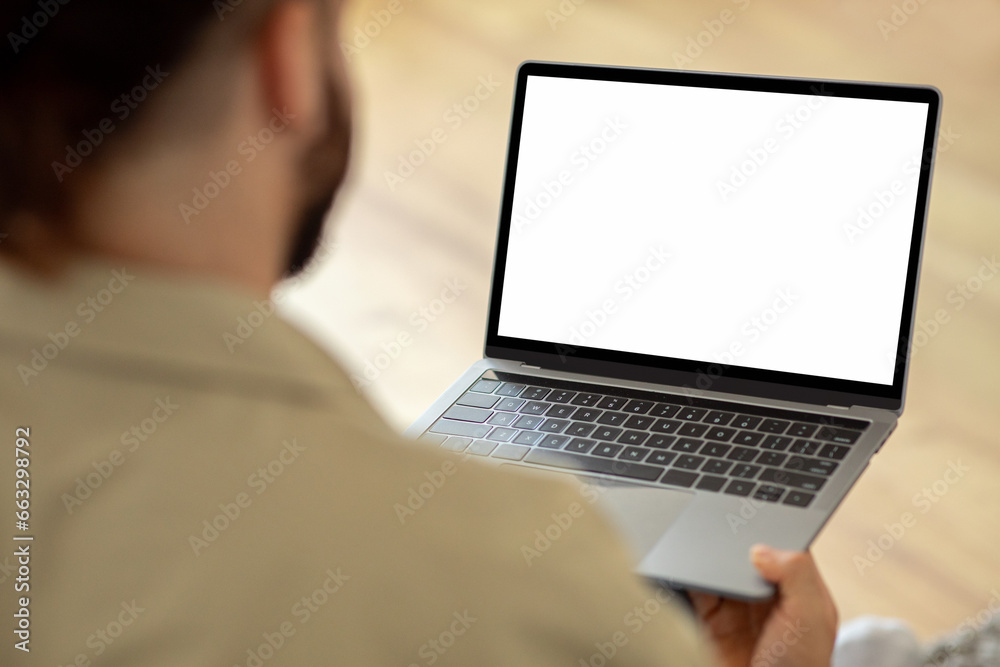 Man Using Laptop Computer With Blank White Screen Man Using Laptop Computer With Blank White Screen