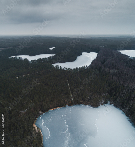 Aerial view of white frozen Jussi lakes, forest and bogs in early winter, Pohja-Korvemaa Nature Reserve, Harjumaa, Estonia. photo