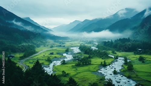 Foggy morning in the mountains. Landscape with green grass and river © Meow Creations