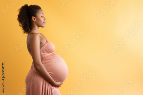A radiant pregnant African American woman lovingly cradling her expectant belly, showcasing the beauty of maternity
