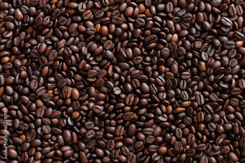 Top view of background representing halves of dark brown coffee beans. Roasted coffee beans  copy space