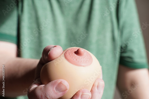hand squeezing or groping boob shaped anti-stress ball photo