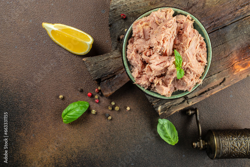 Bilde på lerret Canned tuna steak in brine on a dark background