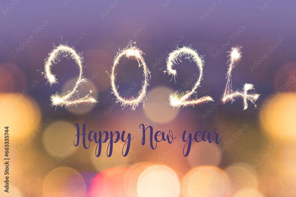 Happy new year 2024 written with sparkles on blurred bokeh lights background, holiday greeting card