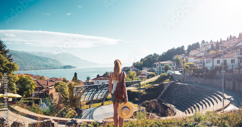 Woman tourist looking at panoramic view of ancient roman theater in Ohrid in Macedonia