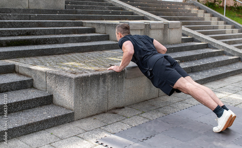 Incline push-up doing by a young athletic man. Push-up modification for beginners