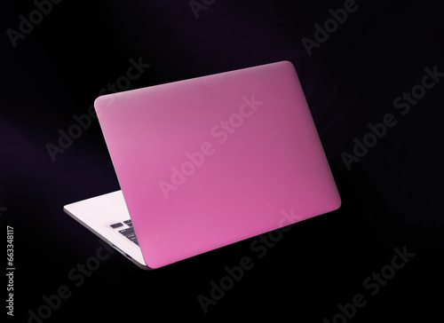 vibrant laptop isolated on dark black background