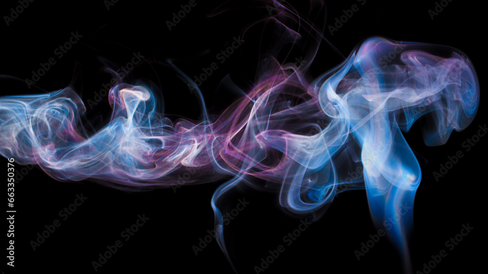 Fototapeta premium Vibrant color incense smoke on black