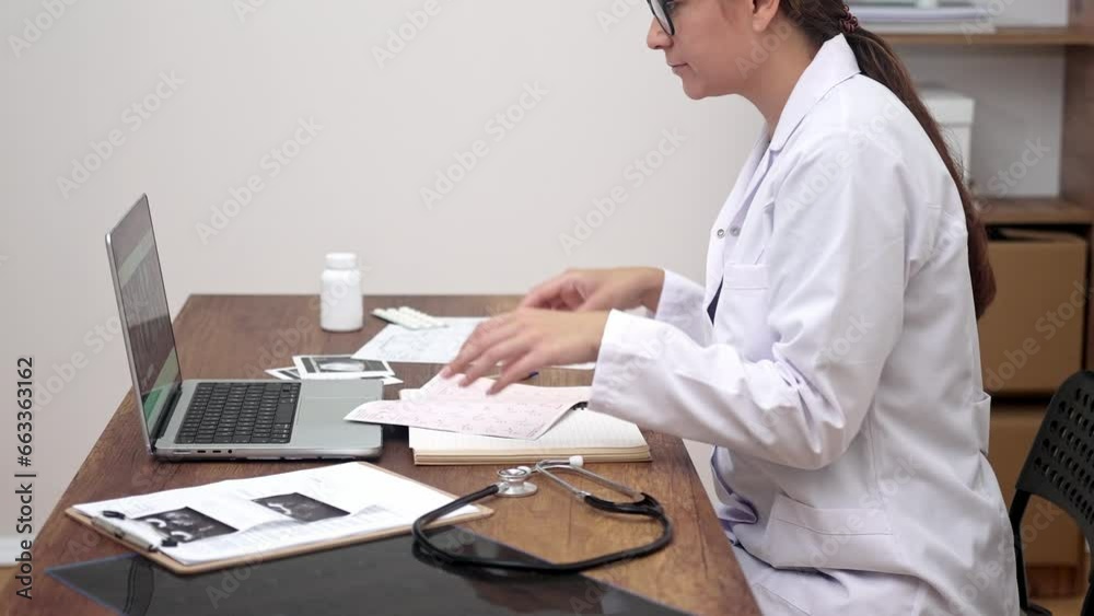 Clinical Record Analysis: In a white lab coat, a female doctor attentively assesses patient medical documents at a table in a contemporary clinic. Clinical Record Analysis: In a white lab coat, a female doctor attentively assesses patient medical documents at a table in a contemporary clinic.