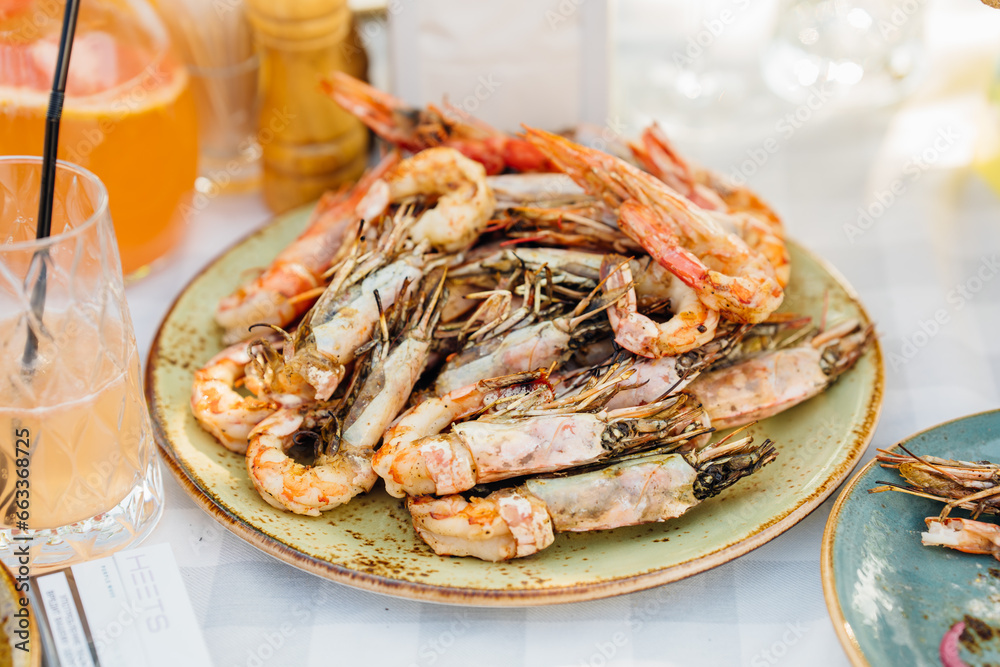 plate with Cooked seafood on a barbecue grill. Grilled shrimp. plate with Cooked seafood on a barbecue grill. Grilled shrimp.