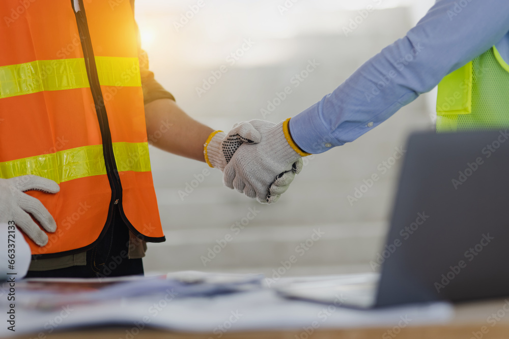 Two engineer shaking hands with project planning and congratulations. Two engineer shaking hands with project planning and congratulations.