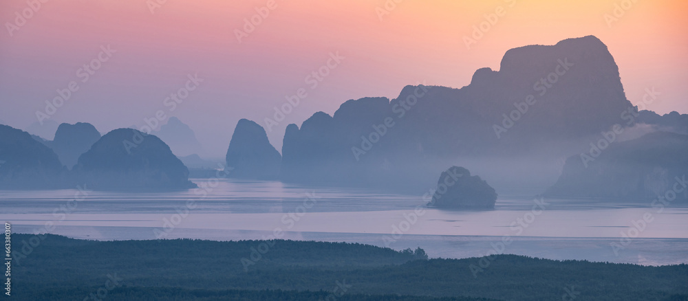 Obraz premium Panoramic view of Phang Nga Bay during sunrise. View from Samed Nang Chee or Samat Nangshe viewpoint, one of travel destinations in Phang Nga Province, Thailand.