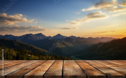 The wooden tables backdrop a breathtaking sunset, sky, and mountains