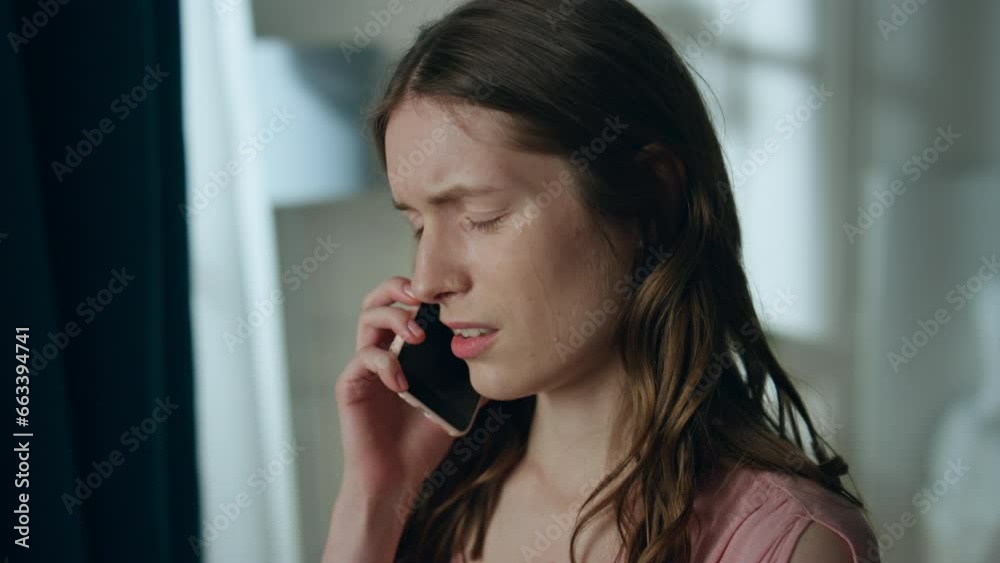 Stressed girl calling smartphone in dark room closeup. Upset young woman talking Stressed girl calling smartphone in dark room closeup. Upset young woman talking