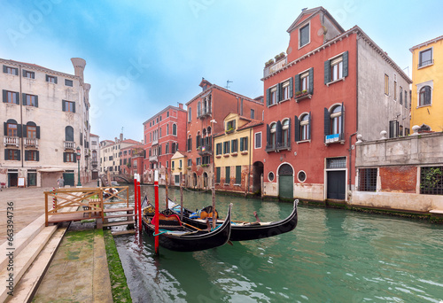Traditional colorful Venetian houses along the canal at sunset. © pillerss