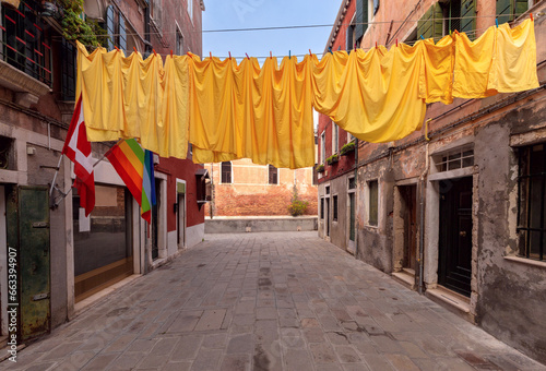 Laundry drying over an old narrow Venetian street.