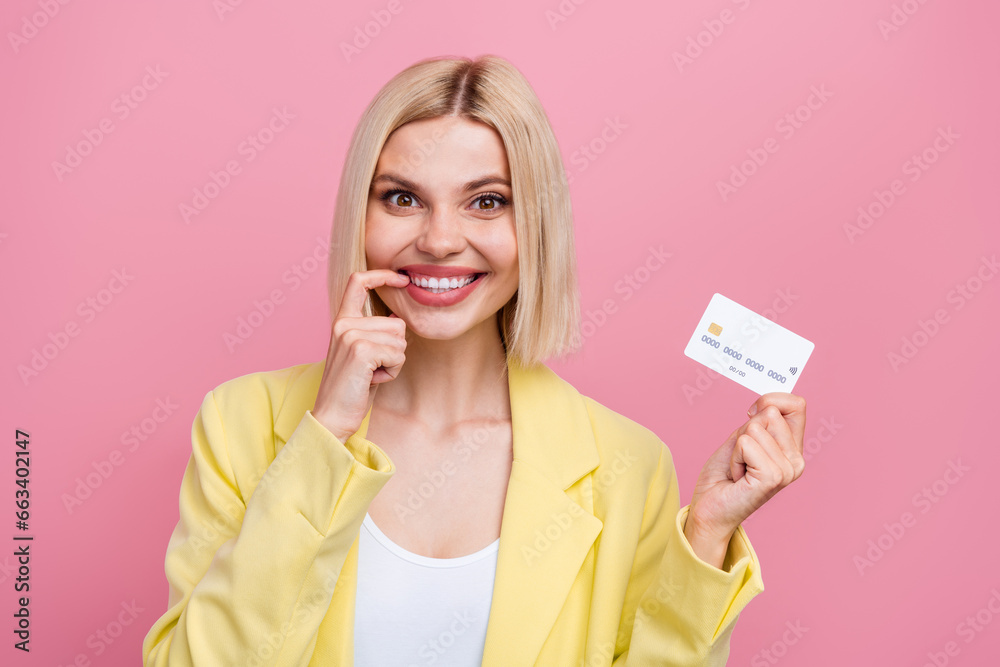 Photo of tricky cunning lady wear yellow jacket suit finger lips holding bank card isolated pink color background Photo of tricky cunning lady wear yellow jacket suit finger lips holding bank card isolated pink color background